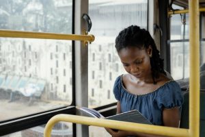 Woman reading in a bus, make time to read!